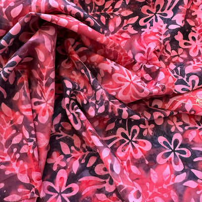 Tela batik óvalos y círculos amarillo naranja rosa sobre morado